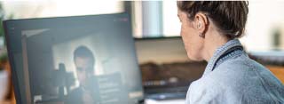 A person with a hearing aid sitting on a video call
